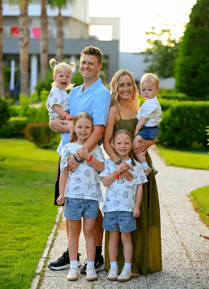 The Slade family smiling together on a sunny day